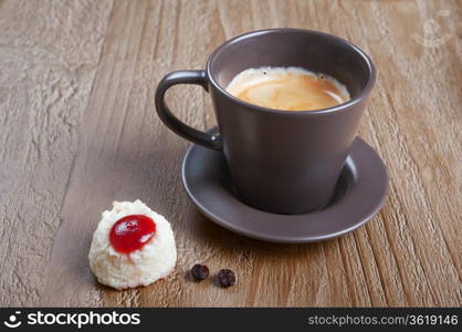 Coffee cup and coco cookie on grunge wooden background