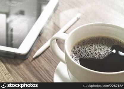 Coffee cup and Digital table dock smart keyboard,eyeglasses,stylus pen on wooden table,filter effect,icons screen