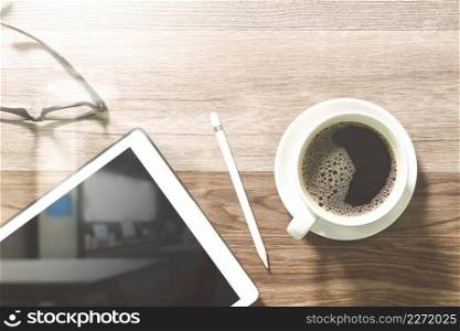 Coffee cup and Digital table dock smart keyboard,eyeglasses,stylus pen on wooden table,filter effect