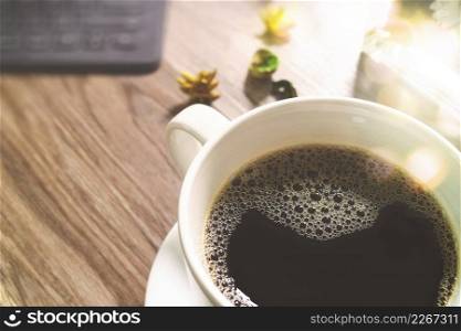 Coffee cup and Digital table dock smart keyboard,gold gift box and round wood tray,color pencil on wooden table,filter effect