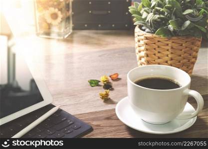 Coffee cup and Digital table dock smart keyboard,vase flower herbs,stylus pen on wooden table,filter effect