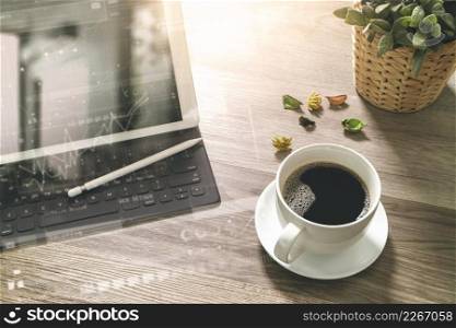 Coffee cup and Digital table dock smart keyboard,vase flower herbs,stylus pen on wooden table,filter effect,icons screen