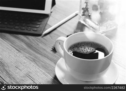 Coffee cup and Digital table dock smart keyboard,vase flower herbs,stylus pen on wooden table,filter effect,black white