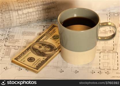Coffee cup and money on architectural design and cad drawing