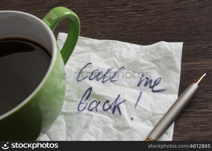 Coffee cup and napkin with message. Romanic message written on napkin on wooden table