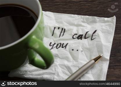 Coffee cup and napkin with message. Romanic message written on napkin on wooden table