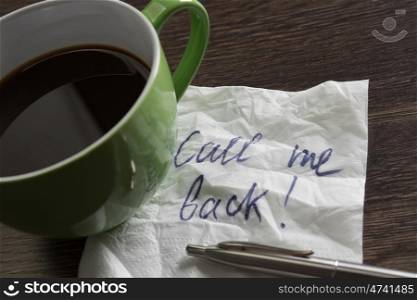 Coffee cup and napkin with message. Romanic message written on napkin on wooden table