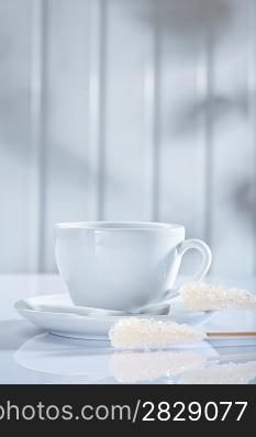 coffee cup and other items on white table