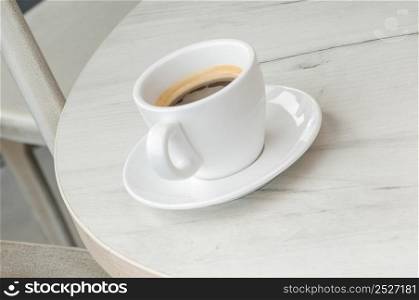Coffee cup and saucer on a round table. cup of coffee on the table