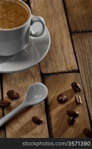 coffee cup and spoon on wooden table