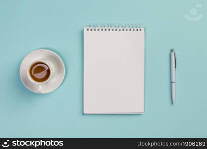 coffee cup blank spiral notepad pen blue office desk. High resolution photo. coffee cup blank spiral notepad pen blue office desk. High quality photo