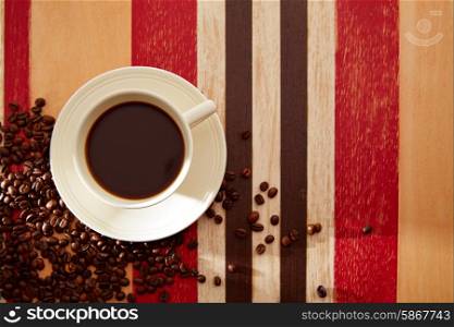 Coffee cup breakfast with chocolate and coffee beans on red brown wooden table