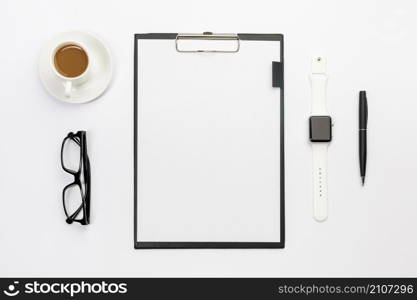 coffee cup eyeglasses smart watch pen blank paper clipboard white desk