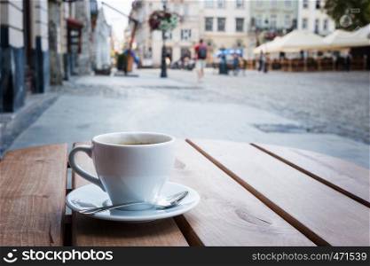 Coffee cup on a table of typical European outdoor cafe