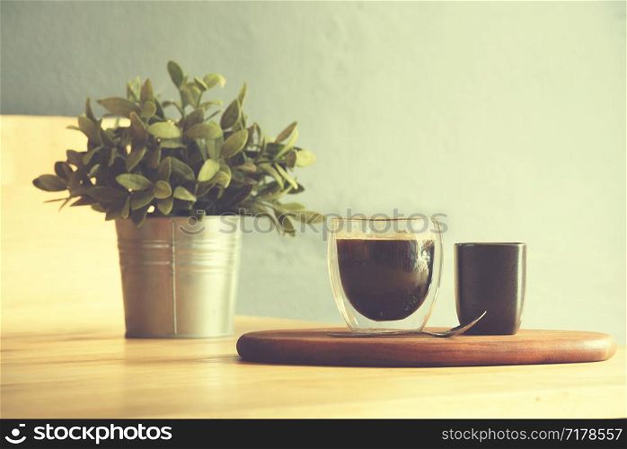 Coffee cup on a wooden table and sack background,Vintage color tone