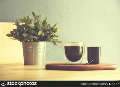 Coffee cup on a wooden table and sack background,Vintage color tone