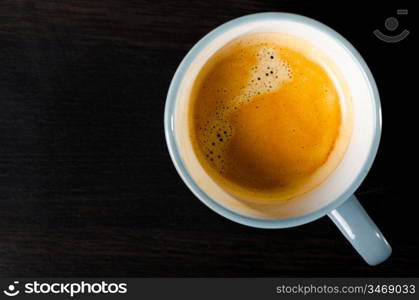 coffee cup on dark table, top view