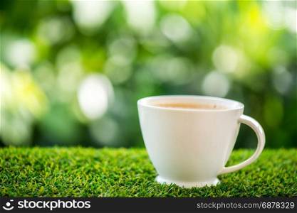 coffee cup on grass floor