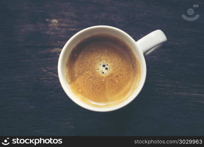 coffee cup on old wooden table background, vintage filter image