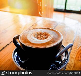 coffee cup on table / cappuccino cup with latte art and sugar on top
