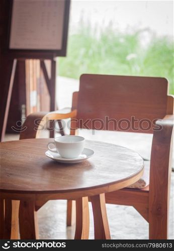 Coffee cup on table in coffee shop, stock photo