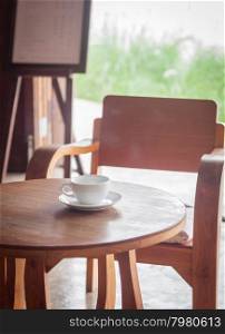 Coffee cup on table in coffee shop, stock photo