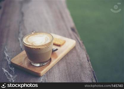 coffee cup on wood table in cafe Vintage tone 
