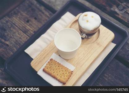 coffee cup on wood table in cafe Vintage tone 