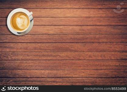 Coffee cup on wood texture and background with space.
