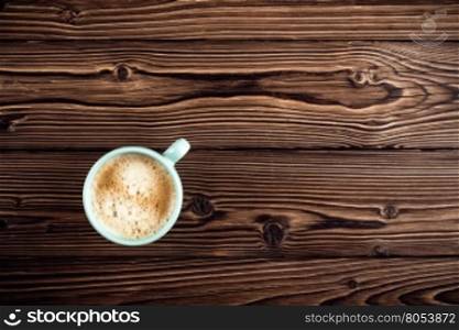 coffee cup on wooden background top view