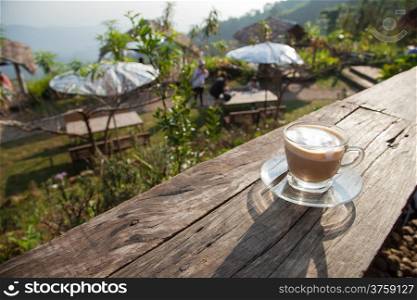 Coffee cup on wooden deck Sun in the morning