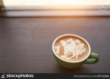 coffee cup on wooden table near window