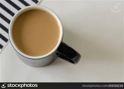 Coffee cup top view, black and white striped background, black c. Coffee cup top view, black and white striped background, black cup,