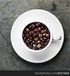 Coffee cup with beans on vintage background
