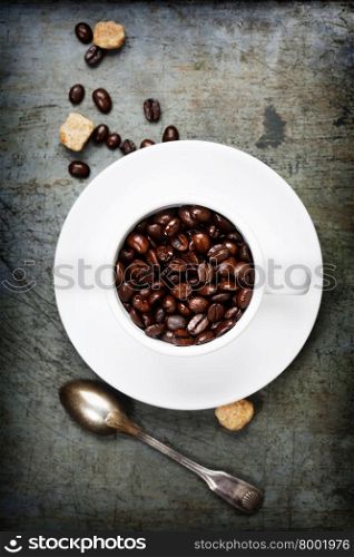 Coffee cup with beans on vintage background