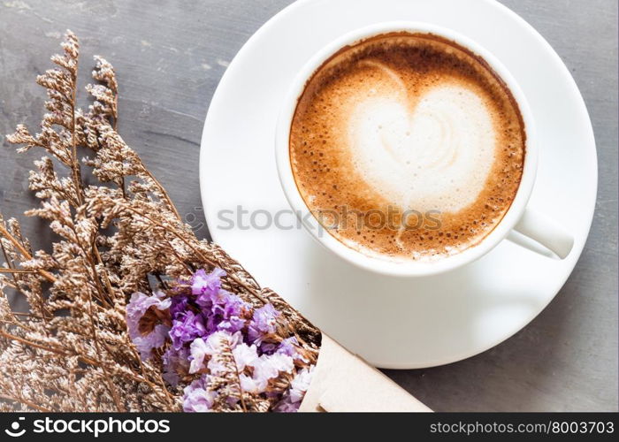 Coffee cup with beautiful violet flower, stock photo