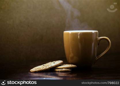 Coffee cup with chocolate cookie on dark wooden background, perfect tasty breakfast, hot. Coffee cup with chocolate cookie on dark wooden background, perfect tasty breakfast