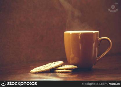 Coffee cup with chocolate cookie on dark wooden background, perfect tasty breakfast, hot. Coffee cup with chocolate cookie on dark wooden background, perfect tasty breakfast
