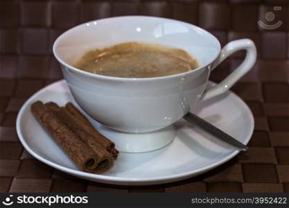 coffee cup with cinnamon sticks