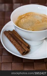 coffee cup with cinnamon sticks