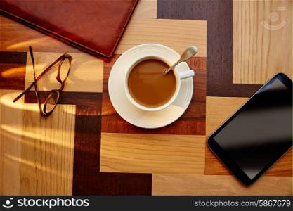 Coffee cup with glasses and tablet pc on table retro vintage