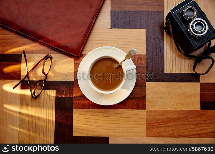 Coffee cup with glasses on table retro photo camera vintage