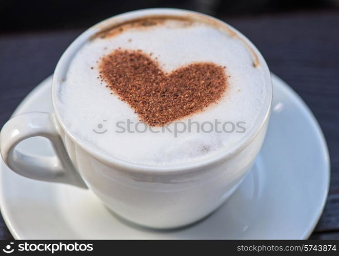 Coffee cup with milk and heart shape. Coffee heart shape