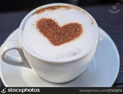 Coffee cup with milk and heart shape. Coffee heart shape