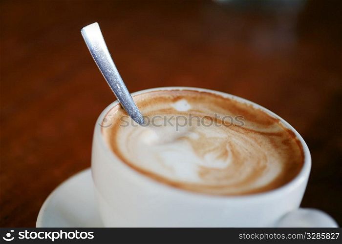 Coffee cup with milk on the table..
