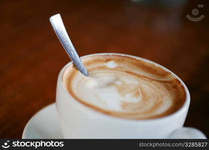 Coffee cup with milk on the table..