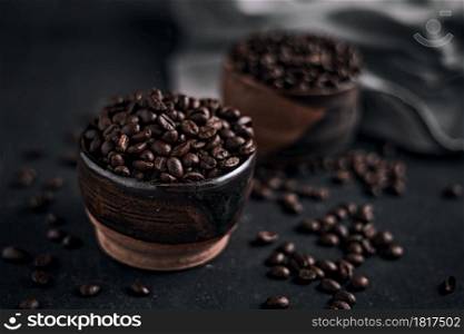 Coffee cup with roasted beans on dark background.. Coffee cup with roasted beans