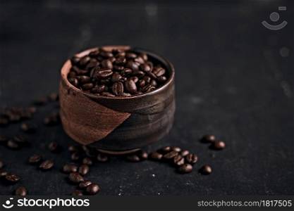 Coffee cup with roasted beans on dark background.. Coffee cup with roasted beans