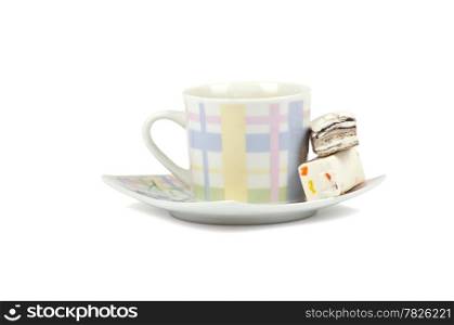 Coffee cup with sweets on white background