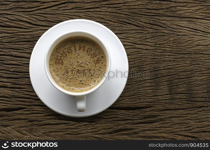 Coffee cup with text Business start motivational handwriting on wood backgrorud